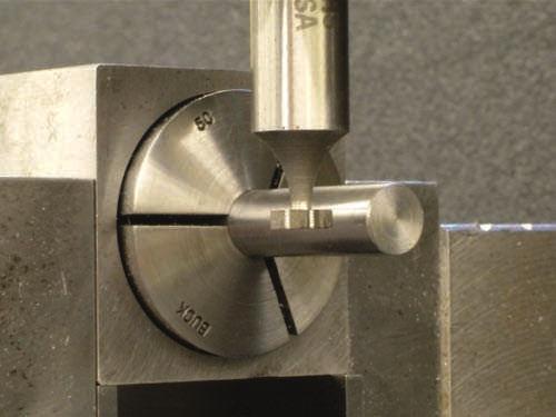 First, position the quill so the keyseat cutter is just above the top surface of the shaft. Use a strip of paper between the bottom of the cutter and the workpiece.