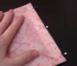 Once the raw edges are folded in where you want them, pin them in place.