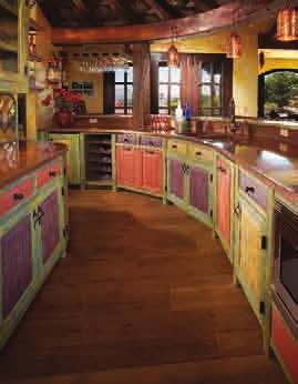 Fiesta kitchen created with custom finishes, constructed of reclaimed Douglas Fir and antique carved Guatemalan beams.
