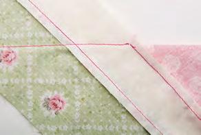 Take one border and fold it back at a 45- degree angle, making sure that the seams align as shown (Photo 4);