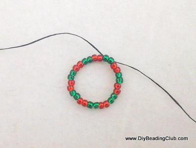 Step By Step Guide Step 1: Creating the wreath - 1st Round Cut at least 25 inches of thread. String 11/0 seed beads - 2 greens and 2 reds, for a total of 28 seed beads.
