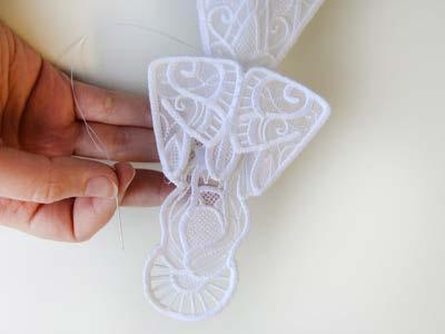 Add the arms (piece "d") to the angel by lining up the shoulders and hand sewing starting at the top points of the