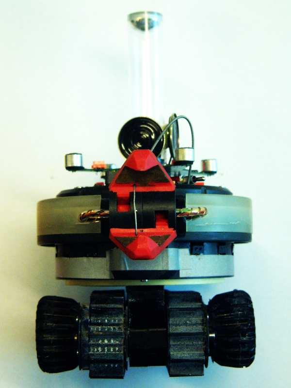 An s-bot is a small mobile autonomous robot with self-assembling capabilities, shown in Fig. 4. It weighs 700 g and its main body has a diameter of about 12 cm.