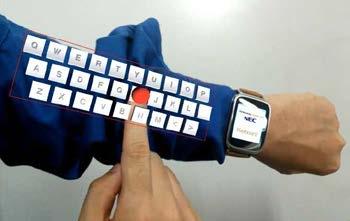 A keyboard and switches are displayed on a worker s arm, and these are used to control the actual measuring device.
