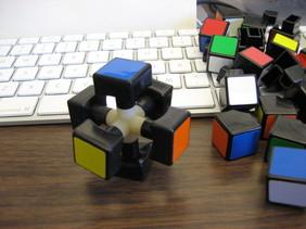 THE 15-PUZZLE (AND RUBIK S CUBE) 7 Figure 3. The center mechanism. Figure 4. A corner and edge piece. F for Front, B for Back, L for Left, R for Right, U for Up, D for Down. See Figure 5.