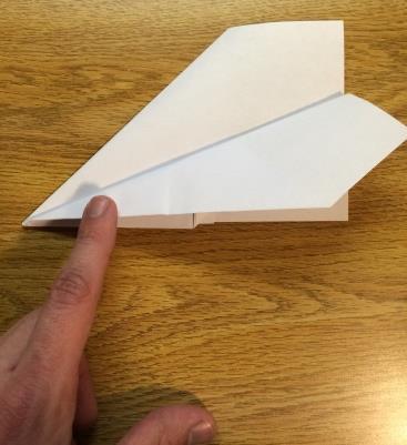 9. Fold one side of the paper airplane down to make its wing The diagonal part of the airplane should be