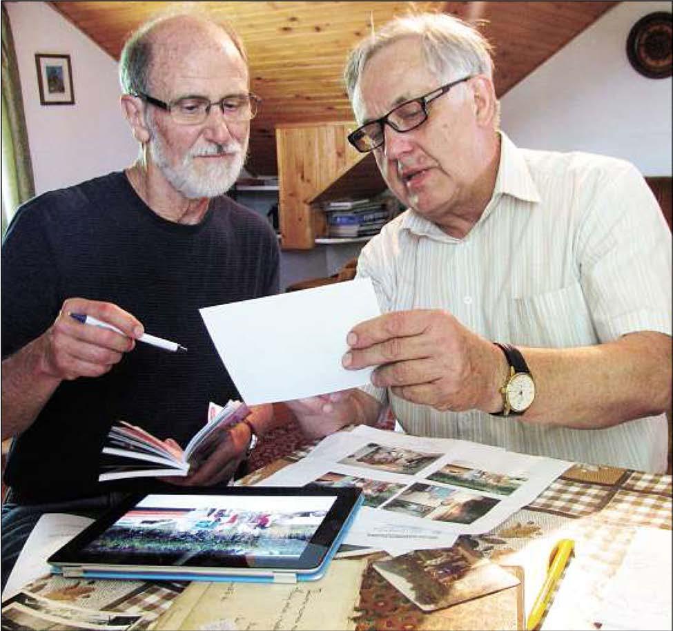 Part Two: Playing bridge in Poland Submitted photo - Malcolm (left) comprares family photos with his cousin Zenon Dudra.