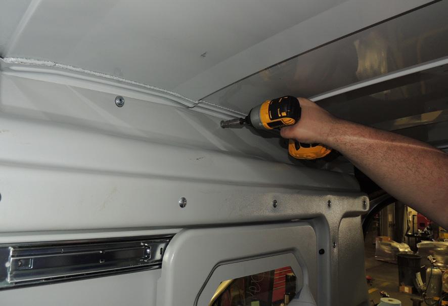 Re-install the grab handle with M6