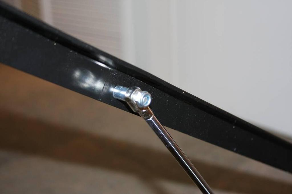 Place gas lift arm over the bolt and secure it using