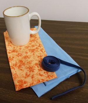 Supplies Needed: **Coffee mug **12" by 12" piece of lightweight canvas, twill, or denim **1/3 yard print cotton fabric (I used quilter's cotton) **Medium weight or lightweight cutaway stabilizer