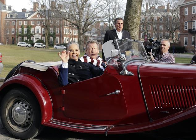 Actors Ali MacGraw, left, and Ryan O'Neal drive up in an antique MG convertible on the campus of Harvard University in Cambridge, Mass., Monday Feb.