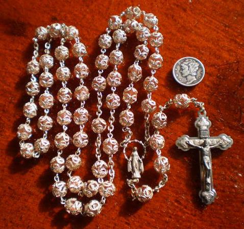 Done in the style of rosaries from the 1940's, this one appears to be a little more recent as the center is typical of 60's and 70's rosaries.