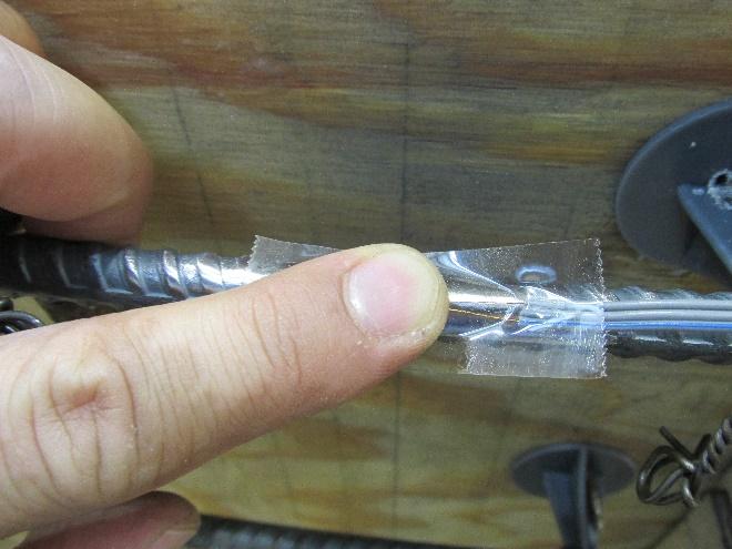 Figure 8 Pressure applied to strain gage and adhesive 4.5.7. Maintain pressure on the tape and gage for approximately 1 minute to allow the adhesive to set and harden.
