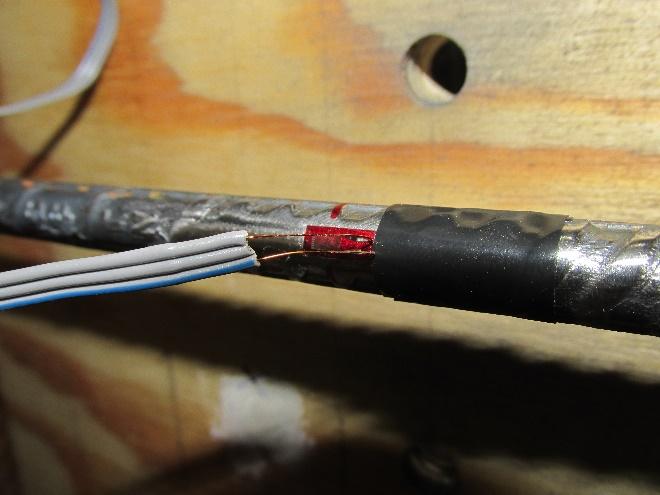 The lead wires can be carefully bent 180 degrees to allow room to apply the electrical tape (Figure 10). The tape should be placed as close to the edge of the gage as possible.