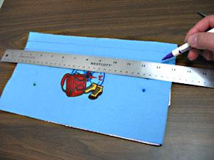 Cut a piece of the Insul-Bright to 13 inches wide by 7 inches high and align the embroidered piece on top, right side facing up (the shiny side of the Insul-Bright should face down). Pin together.
