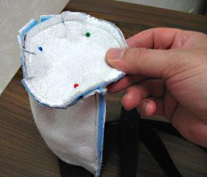 Align the bottom portion with the bottom of the outer shell, pin in place, and sew a 1/2 inch seam around the