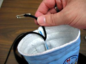 Attach a safety pin to one end, insert the pin into the drawstring pocket and thread the cord through.