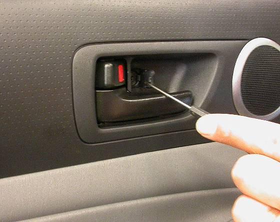 Carefully remove door handle cover using a