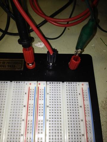 Step 1: Attach power supply positive, negative, and ground terminals to breadboard - Find three terminal inputs (tiny colored cylinders) installed
