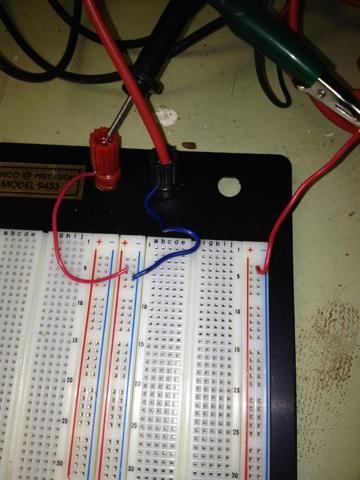 Step 2: Connect terminals to breadboard nodes - Cut and strip three pieces of wire, approximately the length of your index finger - Take one of the wires and connect one end to one of the terminals