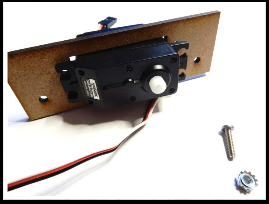Insert the servo motors into the servo holders and secure them with the screws and nuts as shown on the