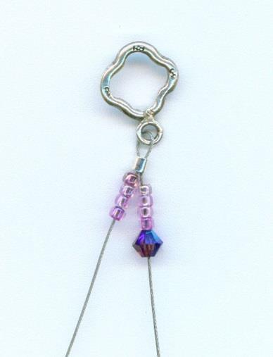 3. String four seed beads on each of the two wires, and put a crystal on one of the wires.