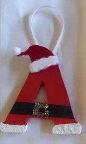 Santa letters Wooden letter Paint brush Hot glue gun Paint (red, white, black, gold) Mini hat ornament (options) Ribbon 1.