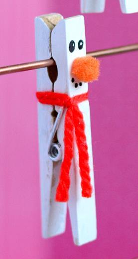 What you need natural wood clothespins yarn in various colors glue orange mini pom poms white paint pain brush black marker Clothespin Snowman 1. Paint clothes pin white 2.