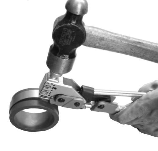 Tension handle should be in down position at completion of tightening clamp. Note: Do not lift tension handle too high as it may open up buckle pusher, resulting in improper clamp application.