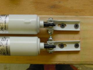 12) Fasten the cylinder mounts to the 2X4 with 1 wood screws, making sure that the cylinders are in good alignment with the scissor mechanism, so that no binding occurs.