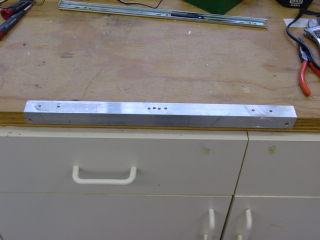 Now let s drill the last two holes. Place the long bracket bar flange down again over the edge of the counter.