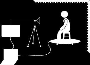 Figure 3. Measurement setup. The person was seated on a chair placed on a turntable inside an anechoic room. A network analyzer connected to a PC was used as a radar.