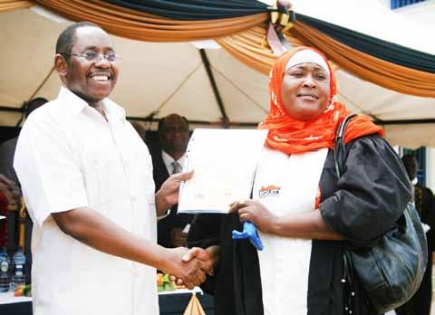certificate to a graduate in Bungoma as Gerald Warui the Director, Human