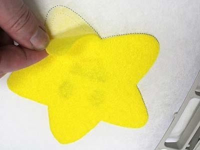 Spray the felt fabric pieces with temporary adhesive and place on the backside of the