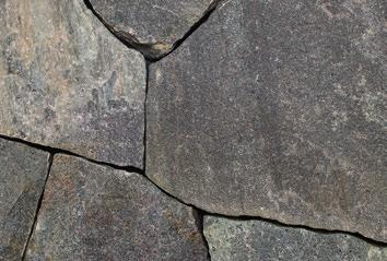 A medium to coarse grain, weathered granite featuring brown, blue, and