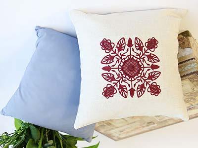 Colored fabric shines through the open areas of these cutwork pillows for a
