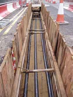 14. APPENDIX F - TYPICAL HIGH VOLTAGE CABLE INSTALLATIONS 14.1 Direct Buried Cable The three conductors are buried in a trench in the ground, sometimes with cooling pipes as well.