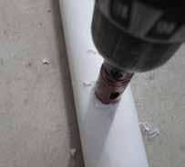 3. Mark the hole locations on each 24" tube and drill the holes for the drain elbows of the channels. Use a 1 3/8" hole saw bit and a drill.
