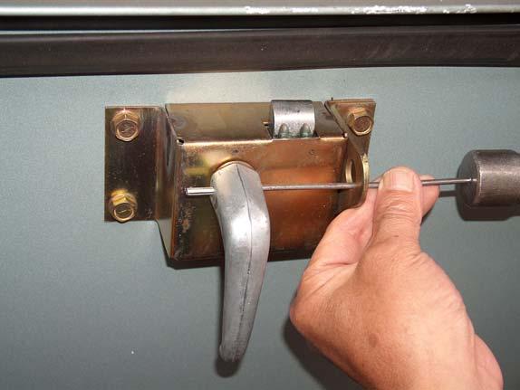 2) Using a 1/8 punch, position so that it is in line with the pin in the handle.