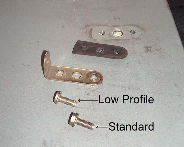 7) With the screws removed, the padlock hasp and the gasket can be removed from the cover as shown in Figure 7.