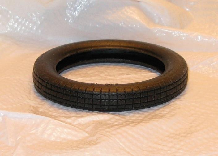 Once the tire is removed from the mold, cut the flange away from the bottom of the tire wall. First use a cut perpendicular to the side wall.