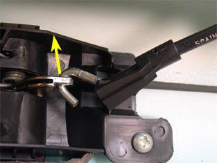 The picture below is a side view of the cable retaining clip to help illustrate how to detach it.