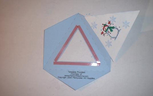 Press flap with tape on the back of the stamped triangle to