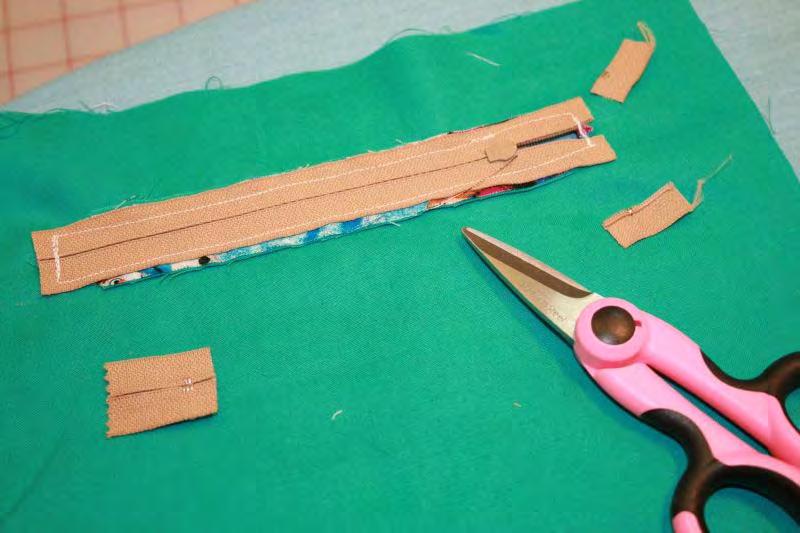 Once the zipper is sewn you can trim off the edges of the zipper tape.