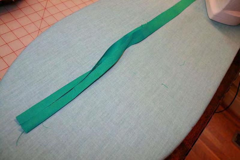 Fold the long piece into the center like the loops.