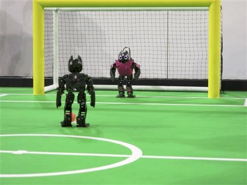 A robot from the RoBIU team fielded by Israel's Bar Ilan university prepares to take a penalty shot at the RoboCup in Eindhoven, Netherlands on Thursday, June 27, 2013.