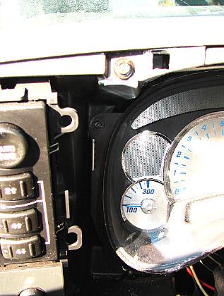 2. The instrument cluster is removed by unscrewing the four screws, one on each corner.