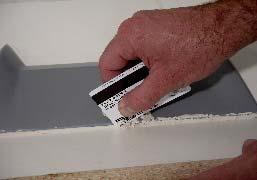 I like to use an old credit card to remove excess clay. You must use something that won t scratch the plug or the base.