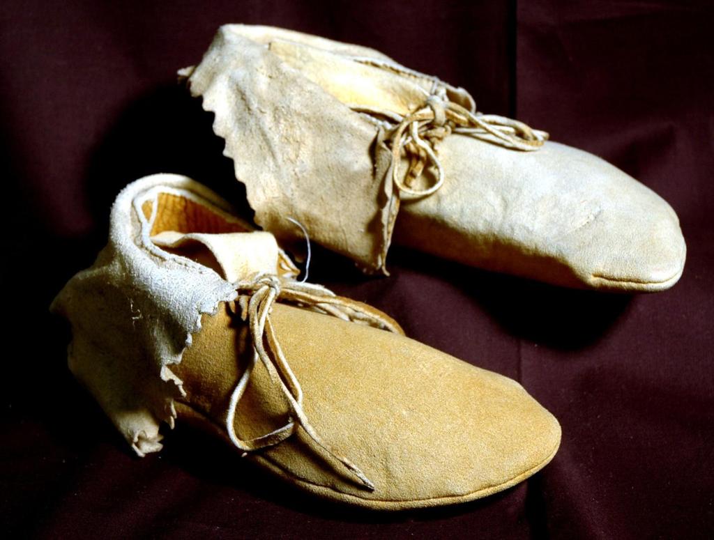 Side-seam moccasins have soft soles and are made of one piece of leather folded and sewn on the outer side.