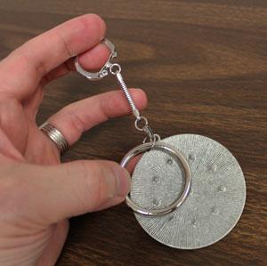 To prepare the top of the chatelaine, add the key ring to the medallion.
